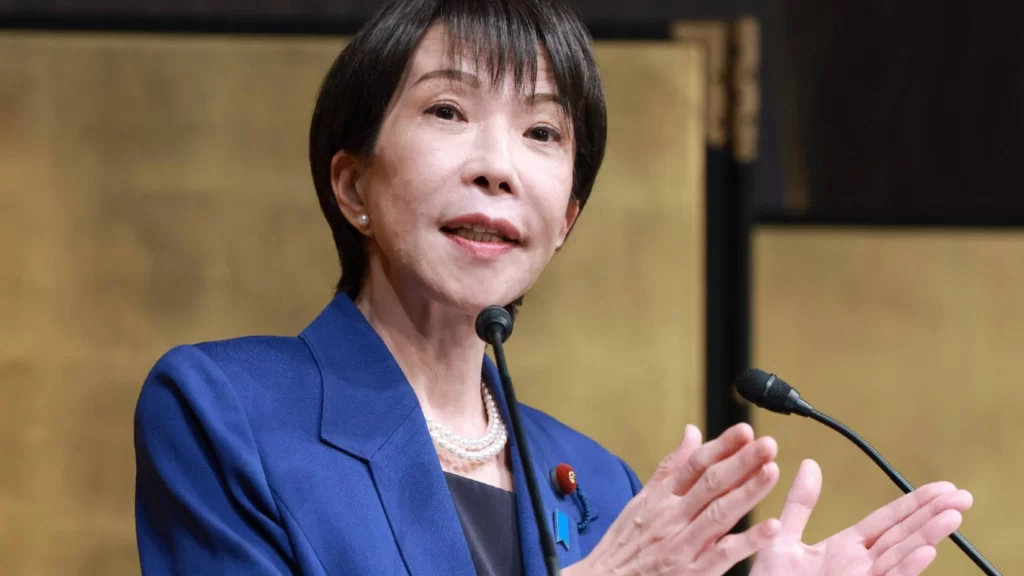 Japanese Prime Minister Sanae Takaichi gestures while speaking about Japan's record-high 9.04 trillion yen defense budget.