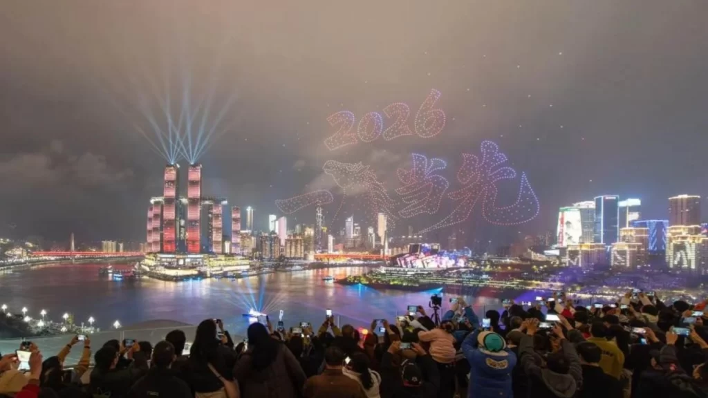 Drones forming a glowing "Die Lian Hua" butterfly and flower motif in Chongqing's night sky.
