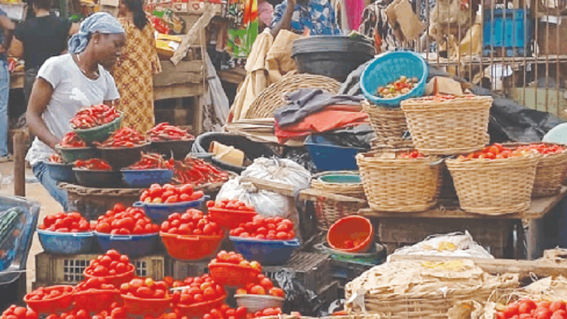 Crowded Lagos market shoppers facing high inflation, buying smaller food portions for a lean Christmas.