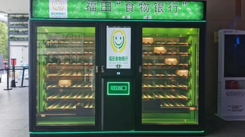 Smart green food bank cabinet in Shenzhen providing free, near-expired food packages to residents.