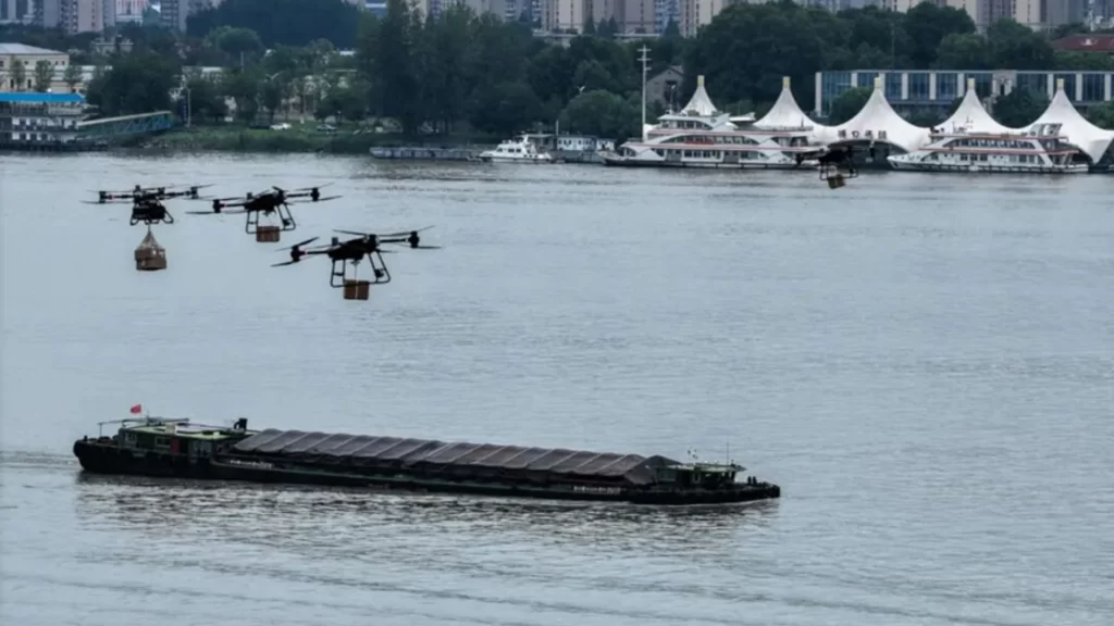 Drone delivering food to a moving cargo ship on the Yangtze River via autonomous cable.