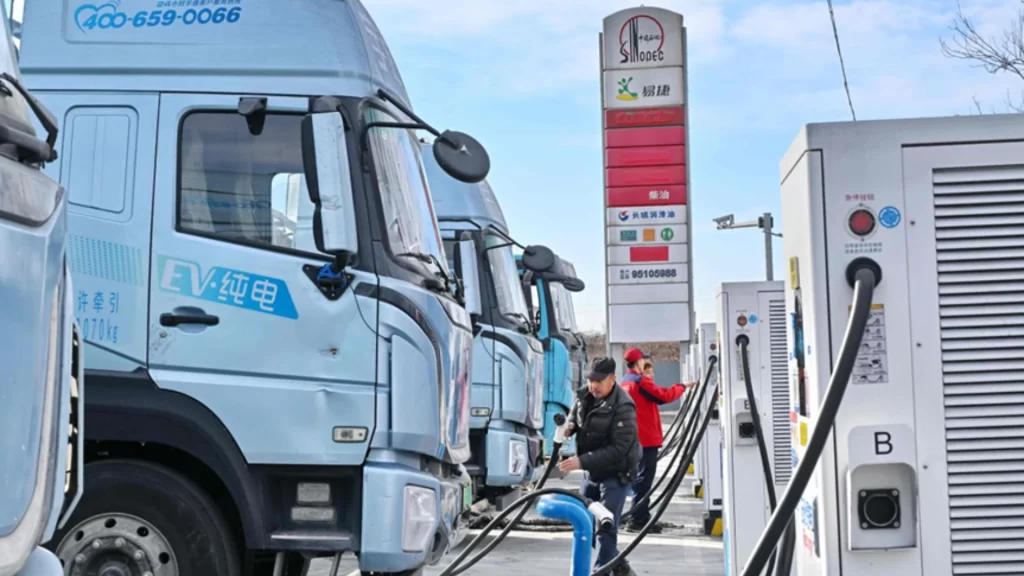 Electric vehicle charging at a highway station with ultra-fast systems and AI-monitored safety equipment.