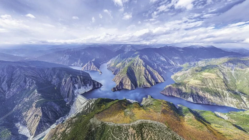 Aerial view of the Lianghekou hydropower dam and reservoir integrated with a subterranean computing center.