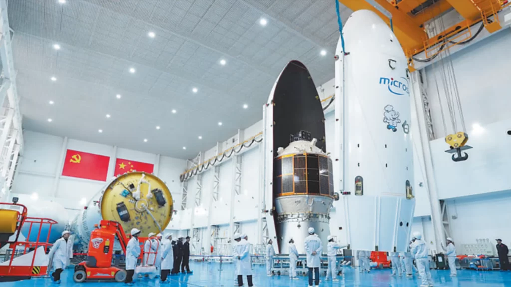 Engineers in a high-tech facility prepare the modular Lijian-2 rocket and Qingzhou cargo spacecraft.