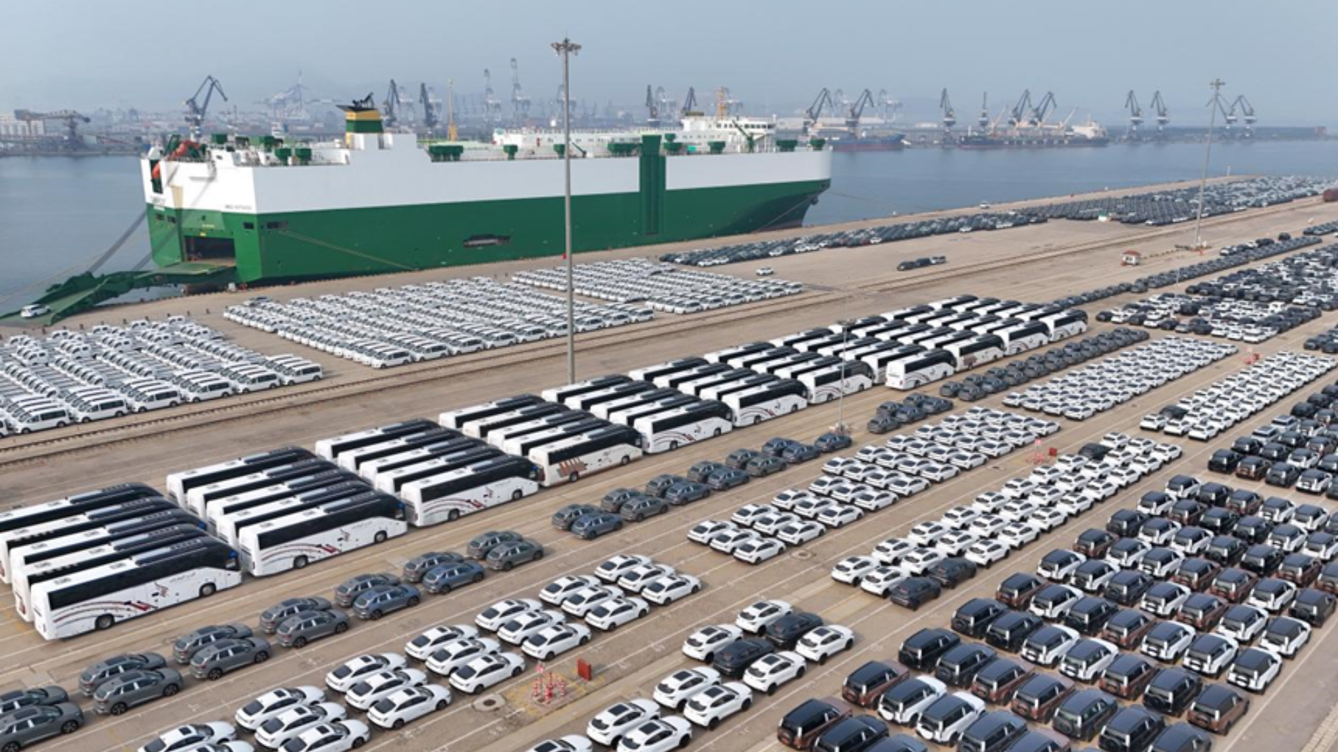 A cargo ship loads thousands of Chinese vehicles for export, marking China's global sales leadership.