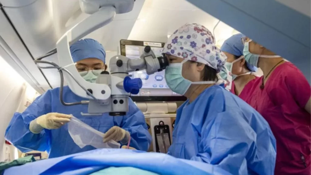 Surgeons perform eye surgery inside the sterile cabin of China's domestically developed C909 flying hospital.