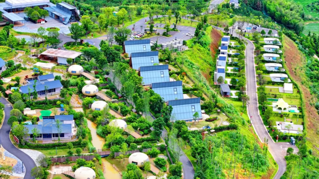 Aerial view of a modular eco-resort in China featuring sustainable, prefabricated dome and cabin housing.