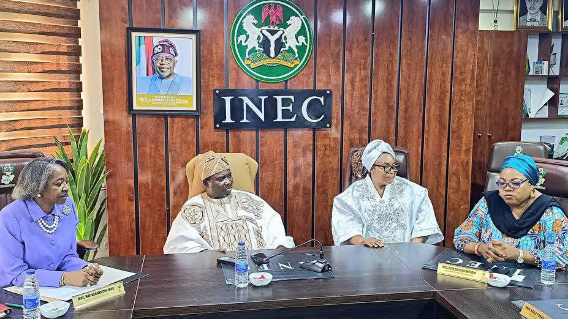 INEC officials seated at a conference table, symbolizing the postponed nationwide voter revalidation exercise.
