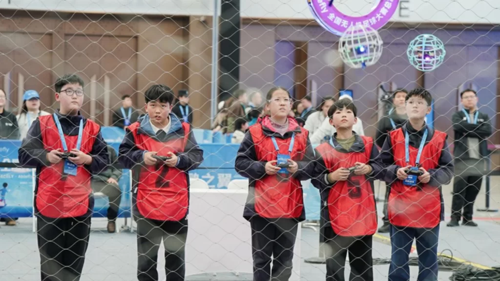 Young players use controllers to maneuver spherical drones during the Ablefly National Drone Soccer Championship.
