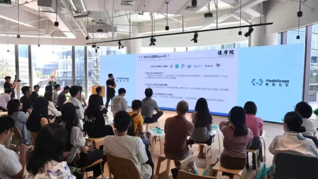 An audience at the ModelScope Developer Center in Hangzhou watches a presentation on multimodal AI models.