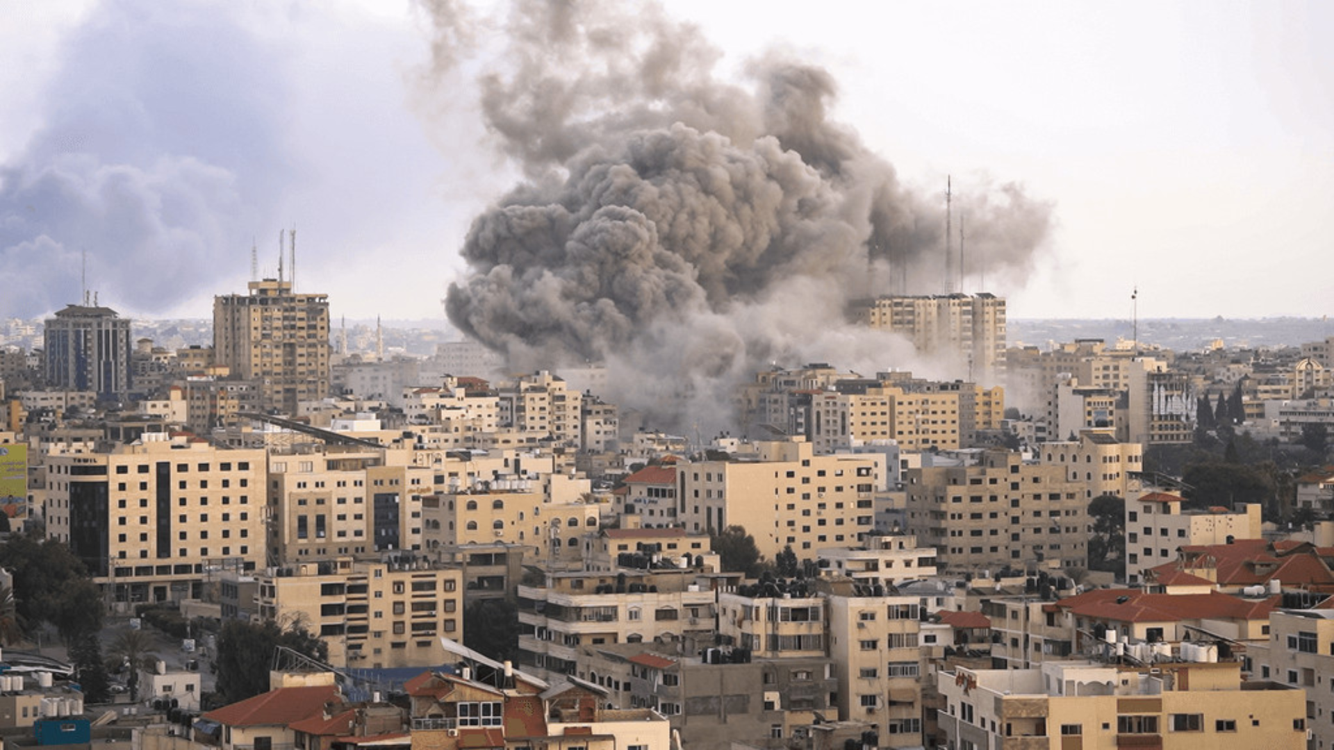 Smoke billows over a city skyline during the Middle East conflict, impacting Nigeria's oil revenue.