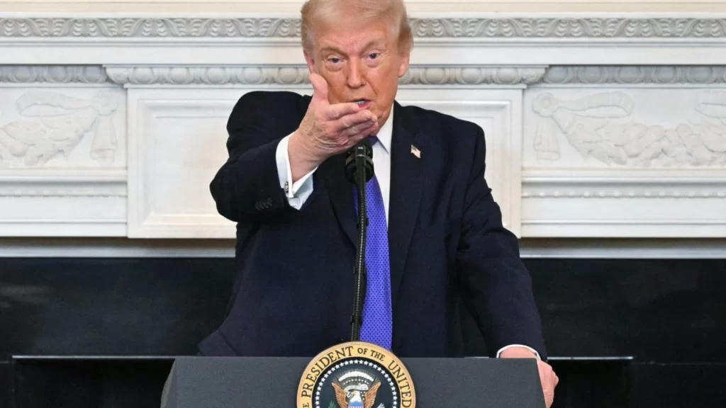 President Donald Trump at a lectern announcing a naval blockade of the Strait of Hormuz.