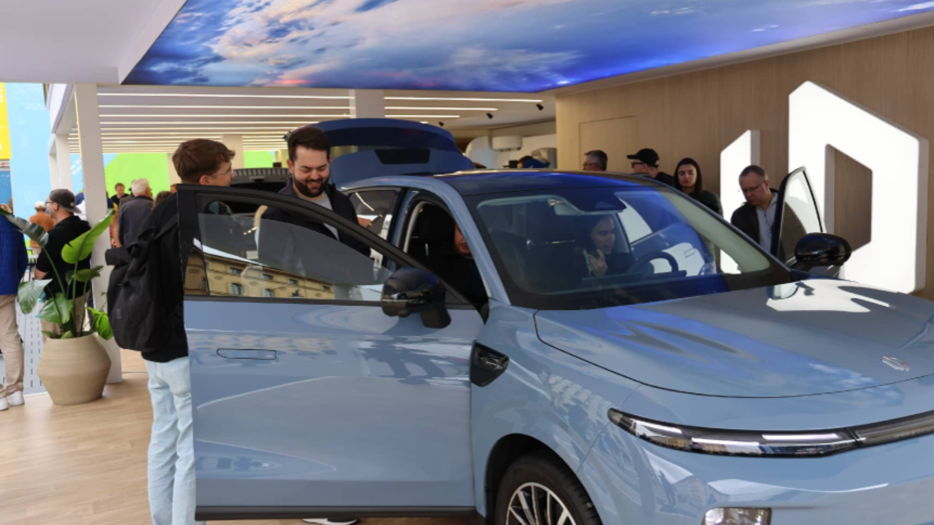 Visitors explore Leapmotor’s new energy vehicles, highlighting growing Chinese and European automotive innovation partnerships.