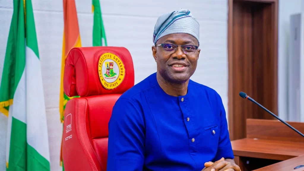 Oyo State Governor Seyi Makinde seated in a red executive chair amidst PDP succession debates.