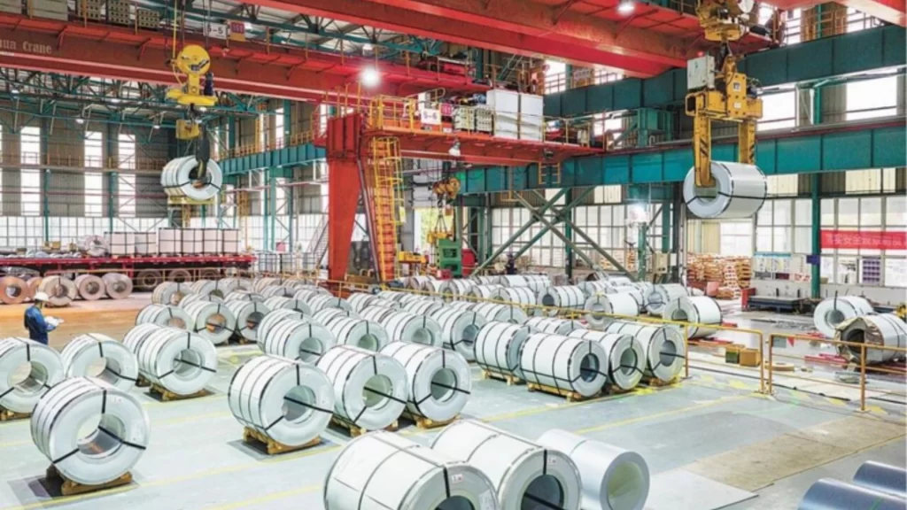 Massive industrial factory warehouse storing and transporting newly manufactured high-performance rolled steel coils.