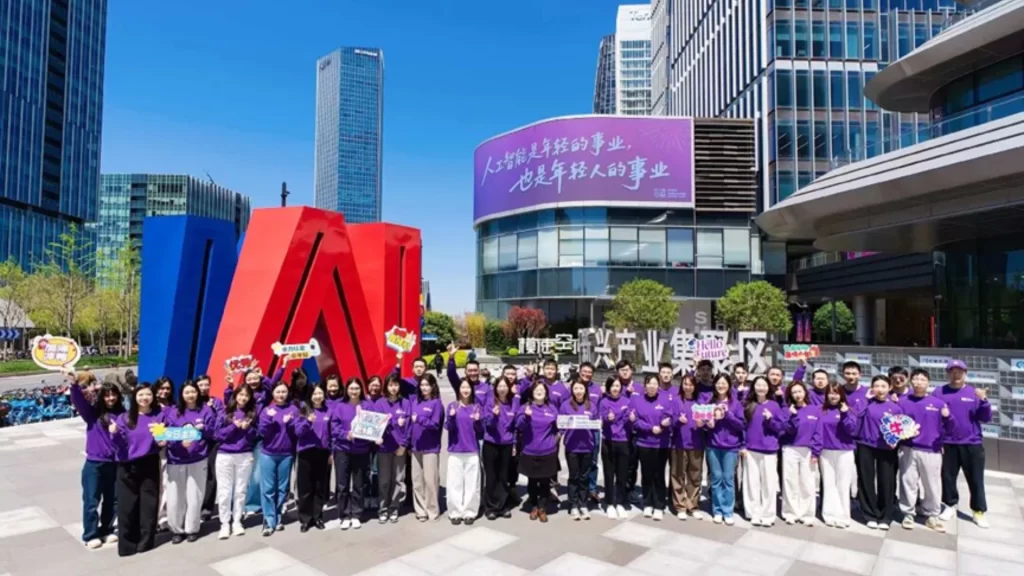 A group of young AI entrepreneurs posing proudly outside the SMC Shanghai Foundation Model Innovation Center.