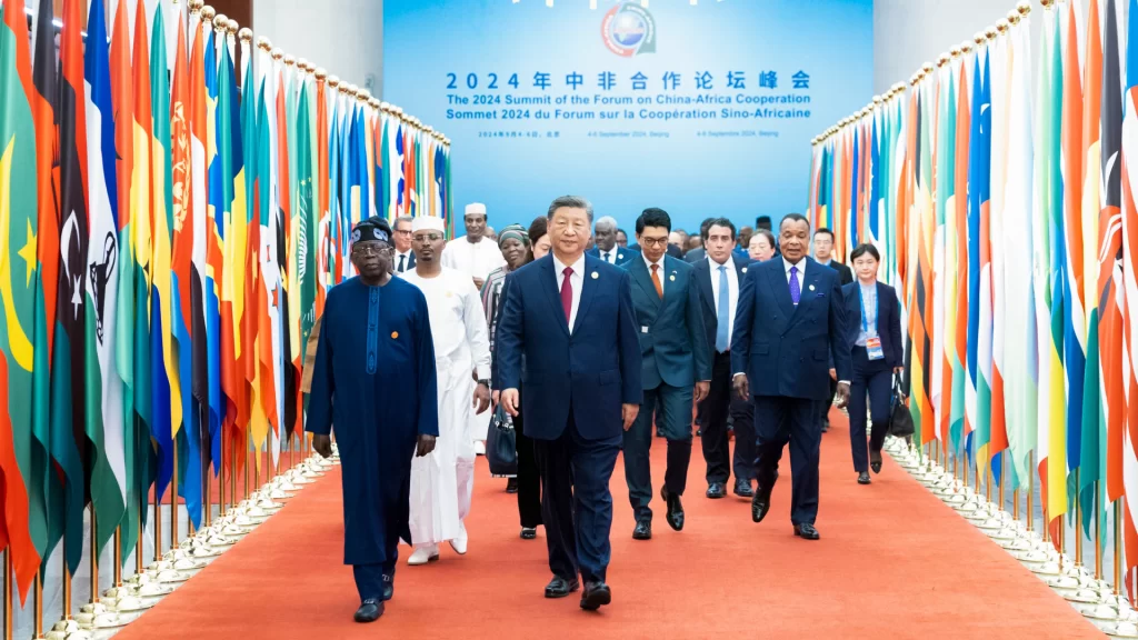 Global leaders walking on a red carpet at the 2024 Summit of the Forum on China-Africa Cooperation.