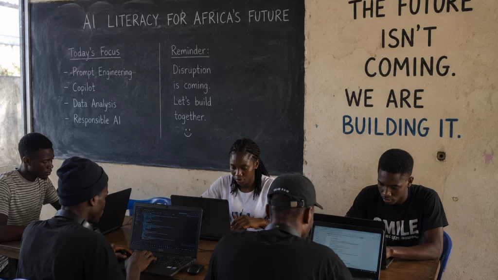Young African students learning AI engineering beneath a chalkboard reading "We are building the future."