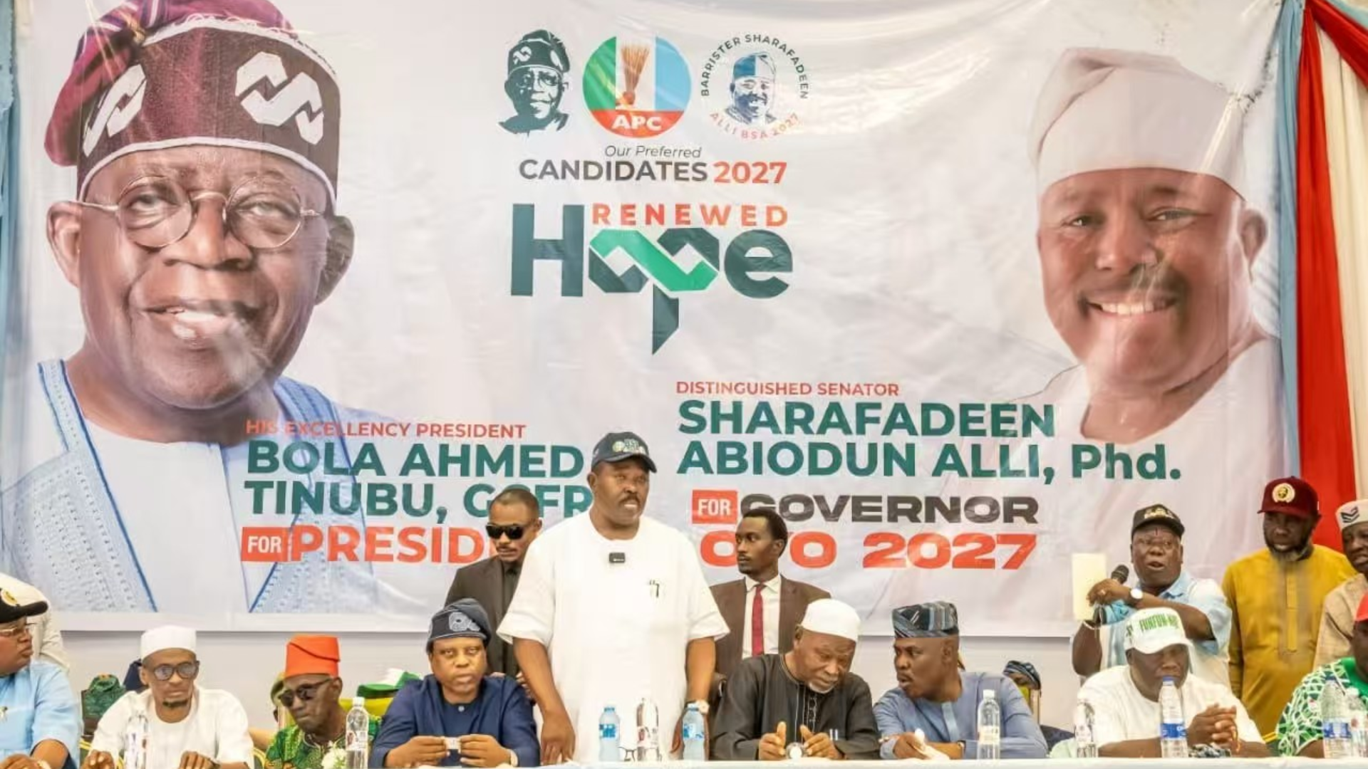 An APC 2027 campaign banner for Bola Tinubu and Oyo State gubernatorial candidate Sharafadeen Alli.