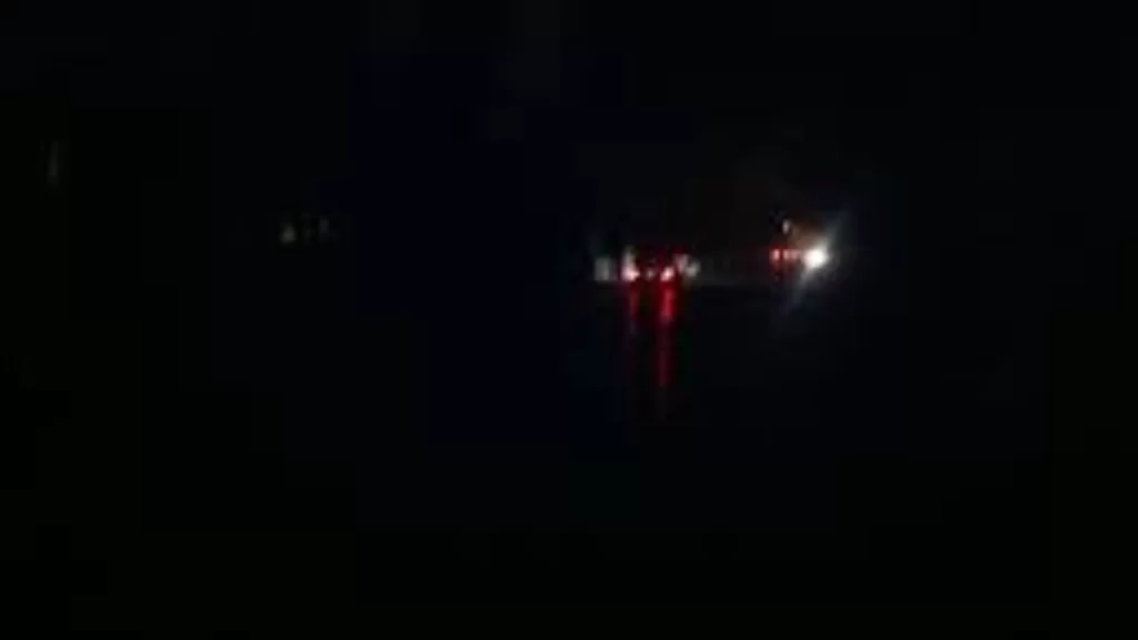 Dimly lit Abuja street where residents adapt and continue daily life during power outages.