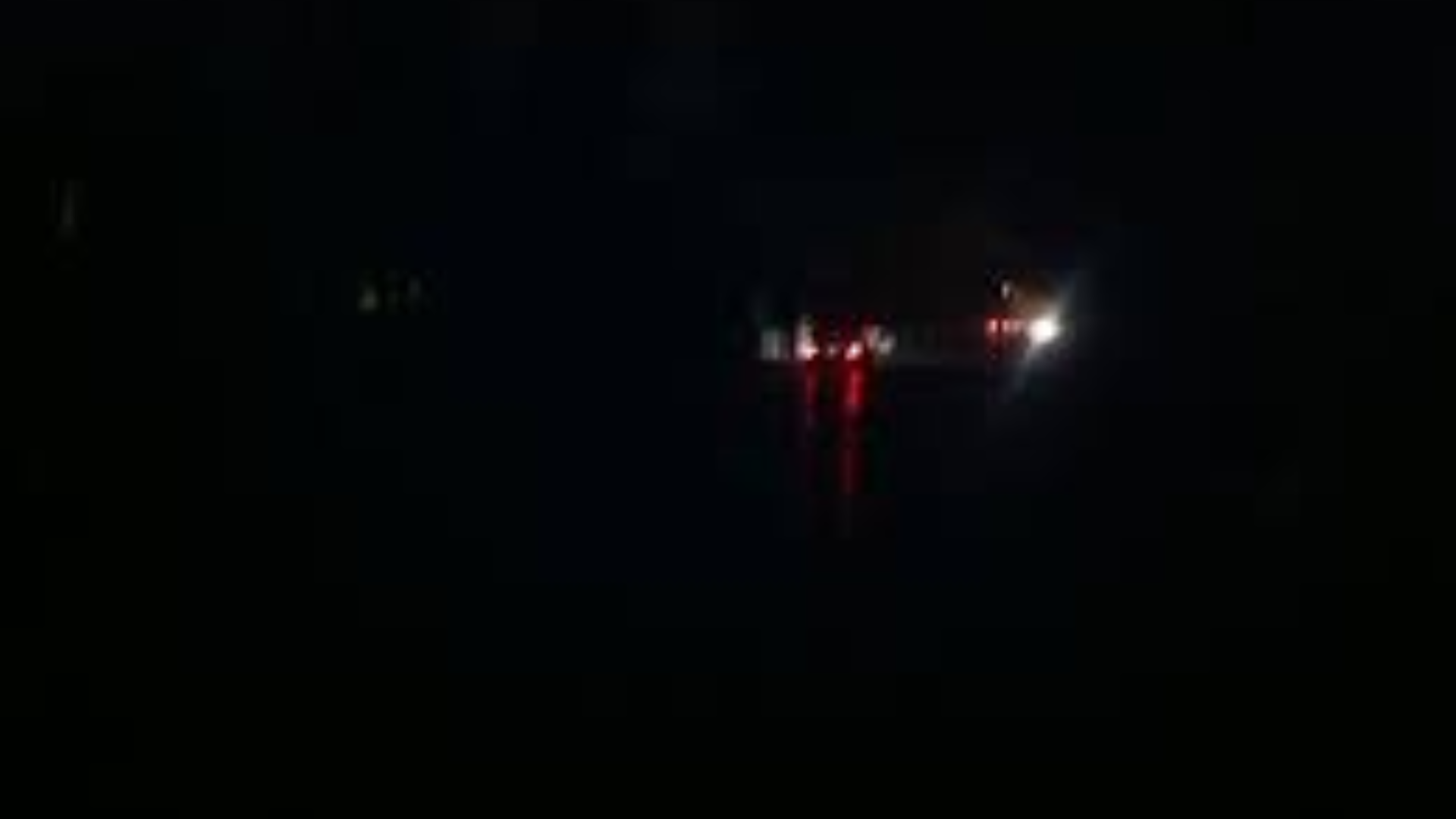 Dimly lit Abuja street where residents adapt and continue daily life during power outages.