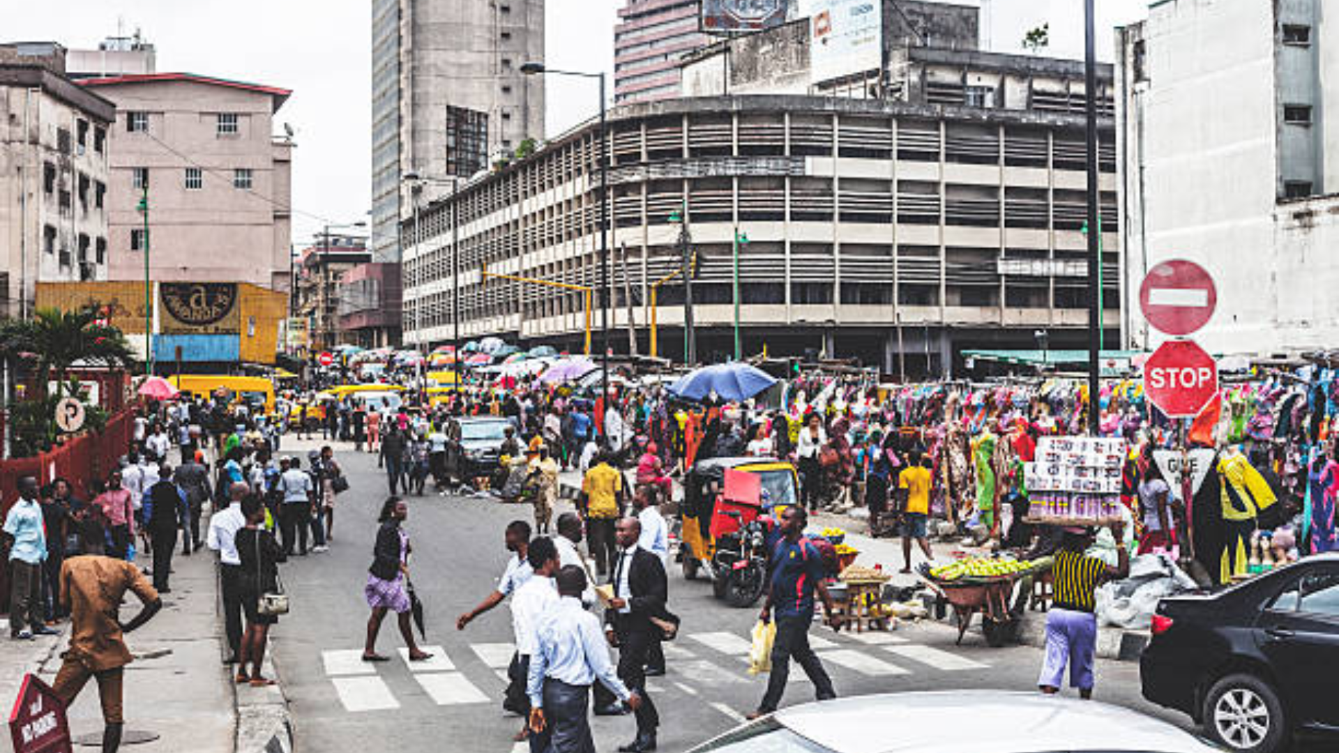A busy city street where reliable infrastructure makes daily life feel dignified and less exhausting.