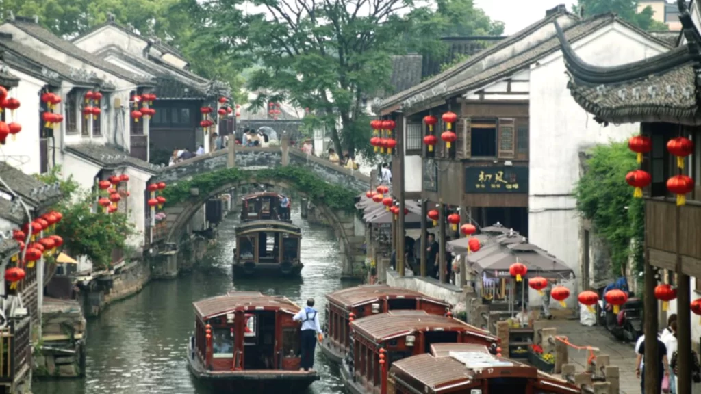Traditional Chinese water town, lantern-lined canals, vibrant tourism and cultural consumption growth.