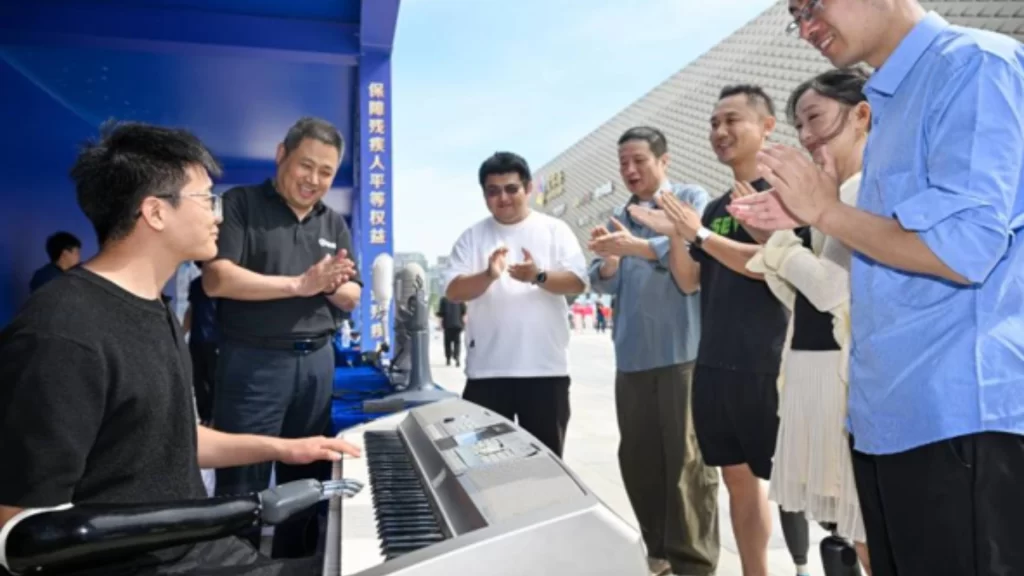 People applaud assistive technology demonstration promoting accessible living and independence for disabled individuals.