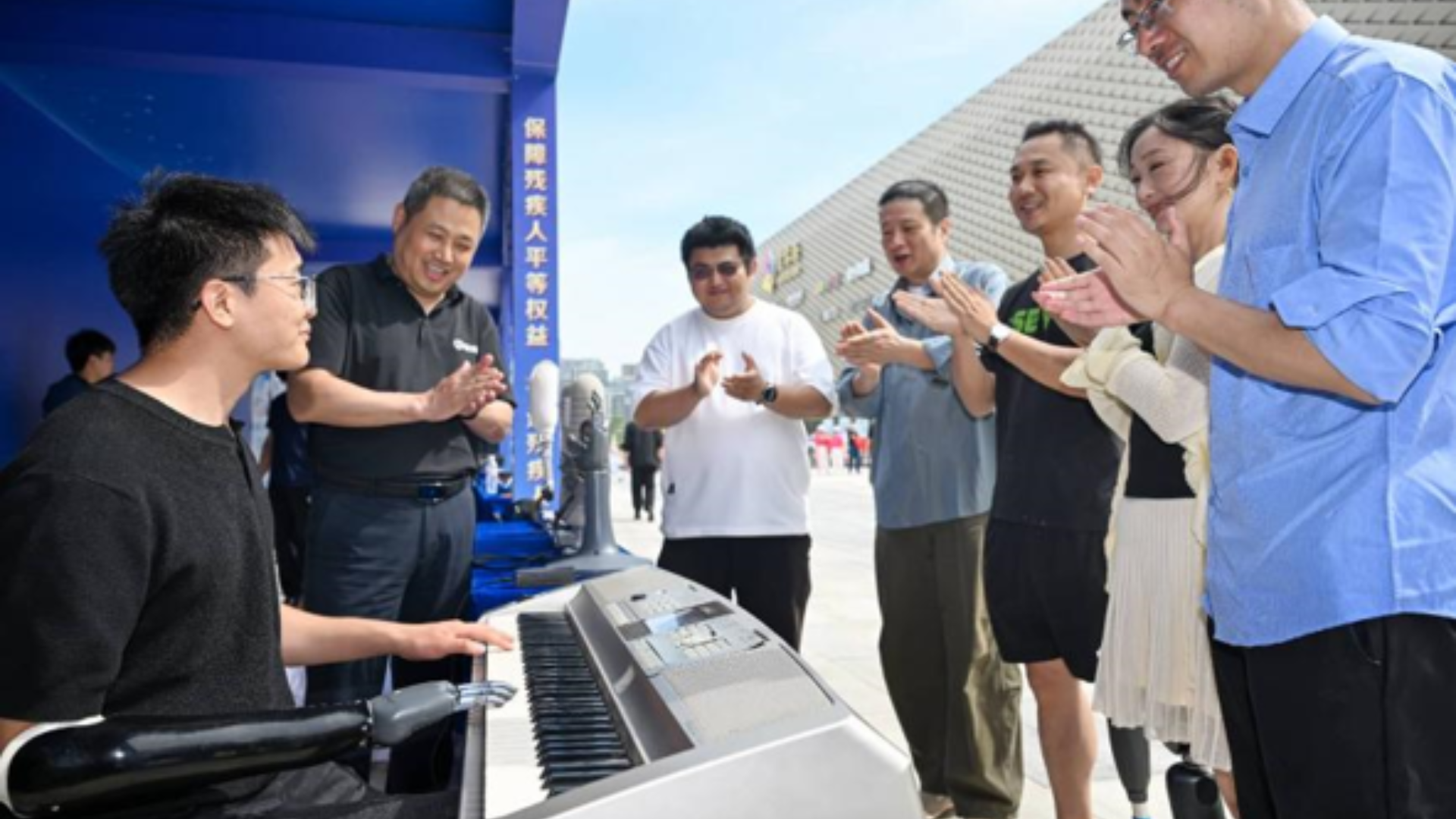 People applaud assistive technology demonstration promoting accessible living and independence for disabled individuals.