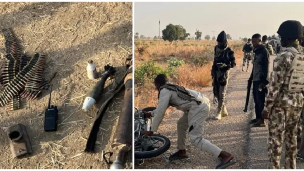 Nigerian troops standing guard near an armored military vehicle during ongoing counter-terrorism operations.