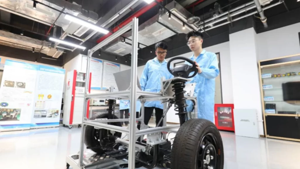Young engineers test new energy vehicle technology at advanced automotive research laboratory.