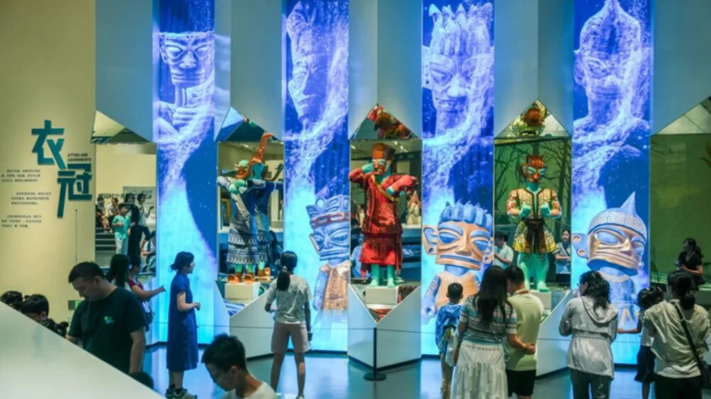 Visitors explore immersive Sanxingdui Museum exhibits featuring interactive digital displays and ancient cultural relics.