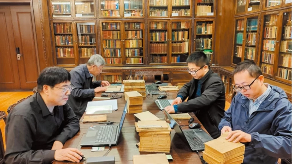 Researchers catalog ancient books in a library for China’s cultural heritage preservation project.