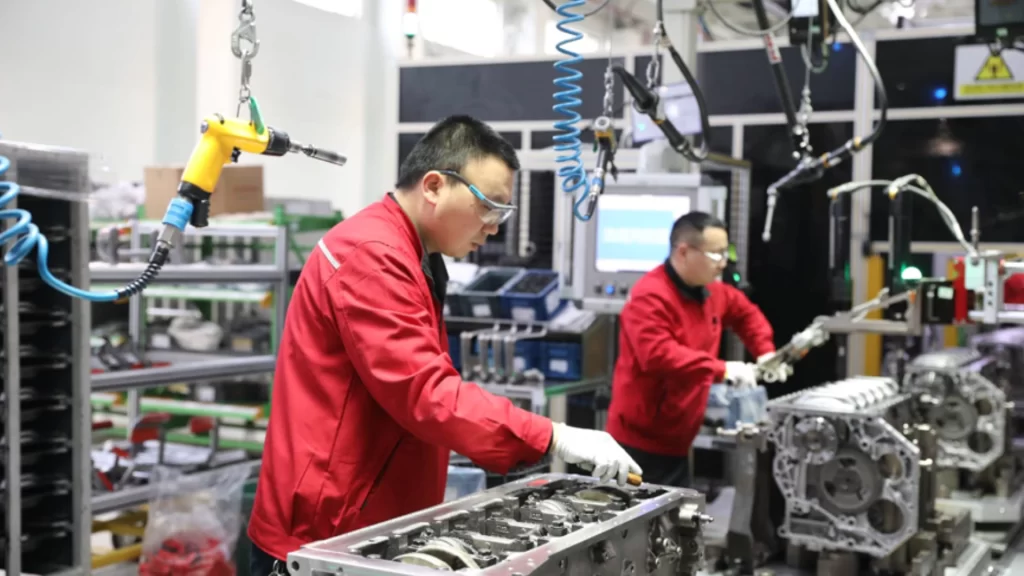 Workers assemble high-tech engines inside an intelligent, green manufacturing factory in China.
