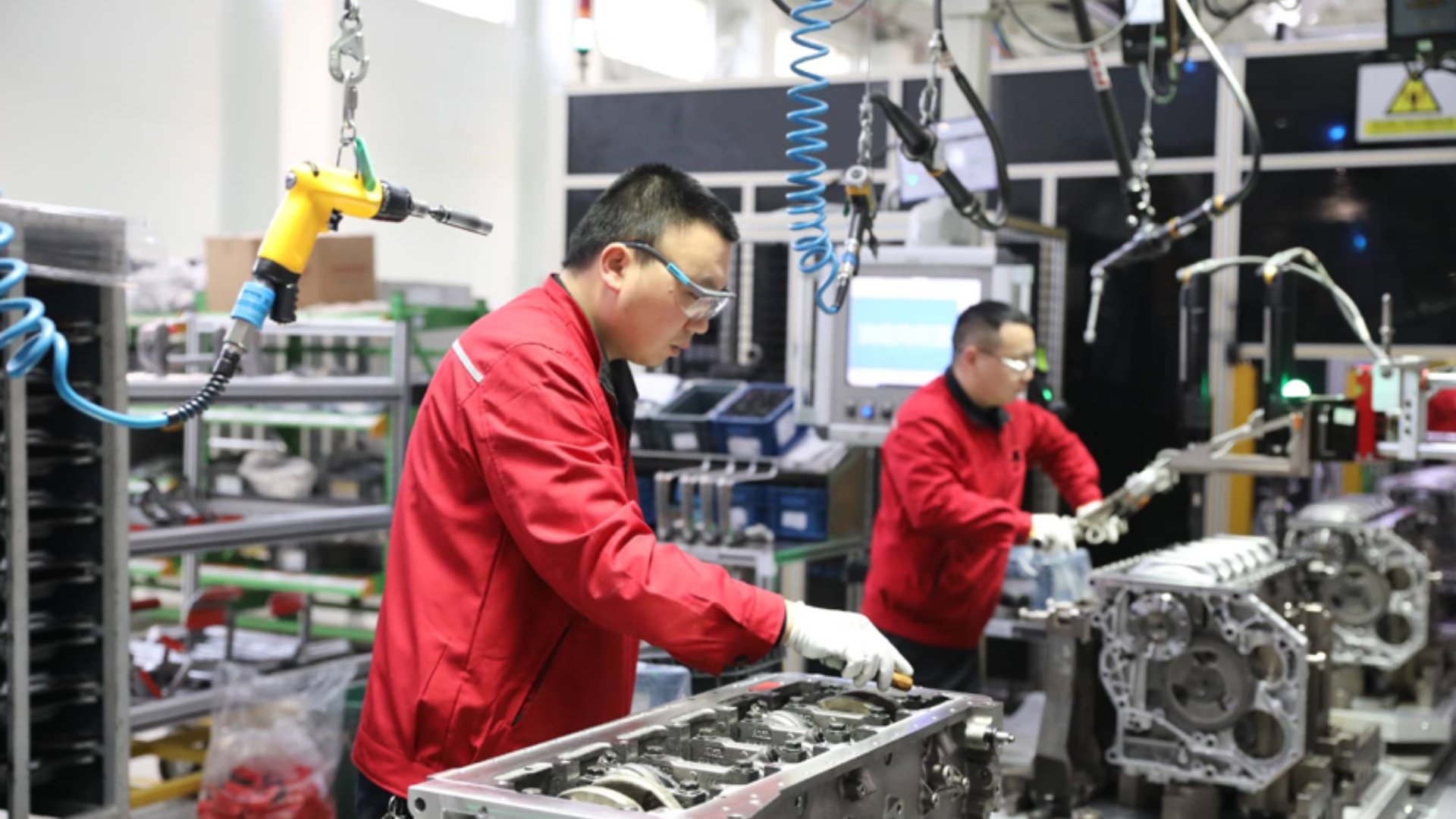 Workers assemble high-tech engines inside an intelligent, green manufacturing factory in China.
