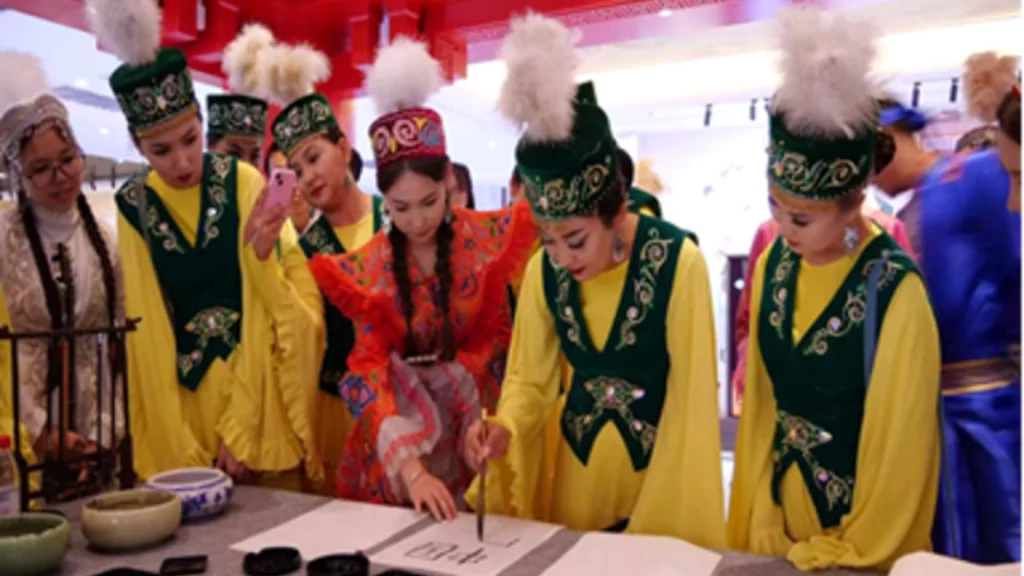 Kazakhstan youths practice Chinese calligraphy during cultural exchange event in Horgos, promoting cross-border friendship.