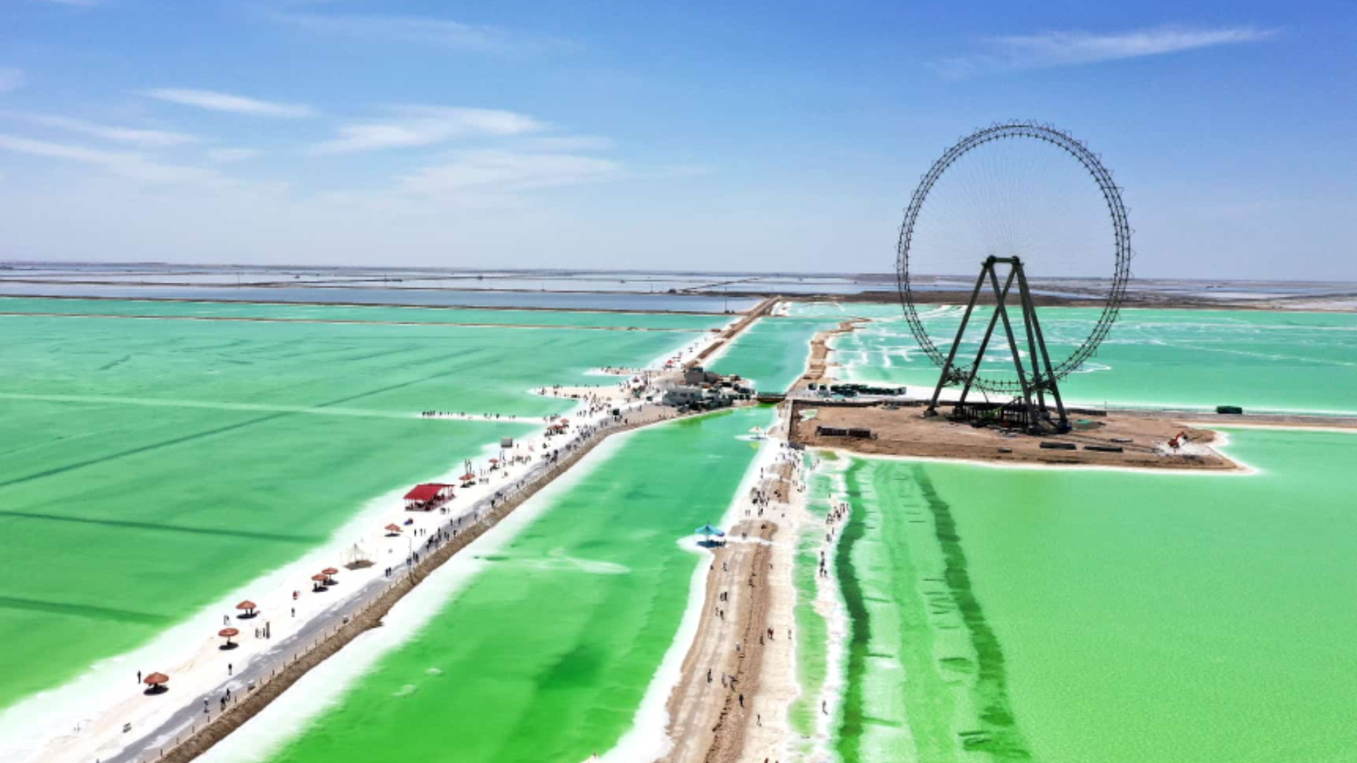 Aerial view of Qairhan Salt Lake showcasing vibrant waters, sustainable resource development, and tourism growth.