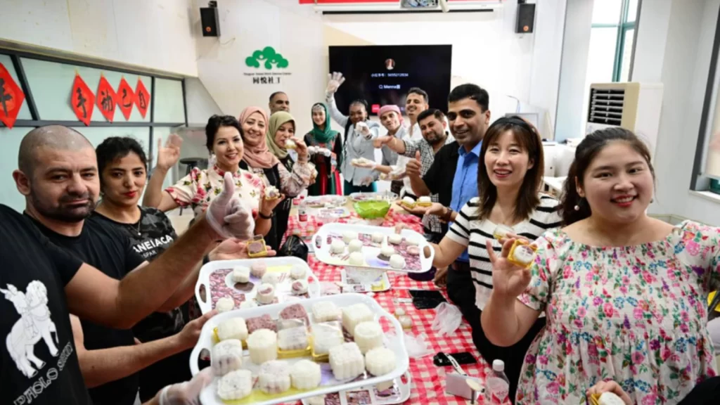 Foreign and local residents celebrate a traditional Chinese festival in Yiwu community.