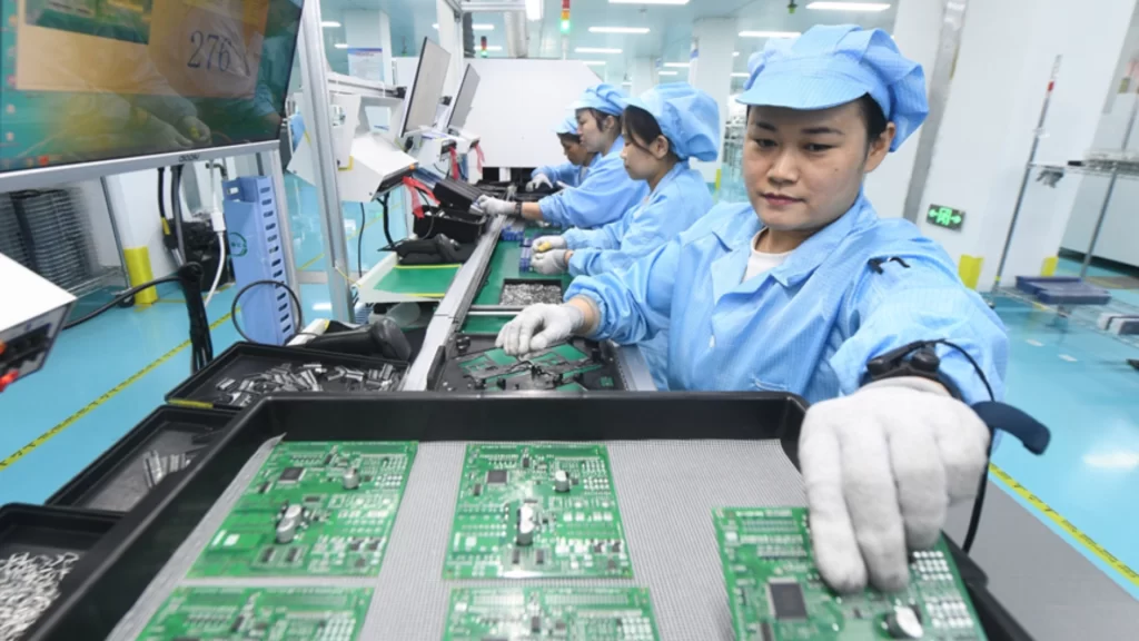 Workers manufacture electronic components for export at Hebei factory, supporting global trade and supply chains.