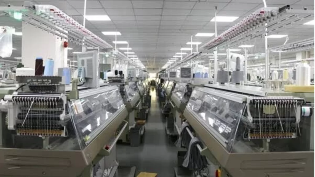 Modern textile factory with advanced knitting machines and automated production lines supporting technology-driven services.