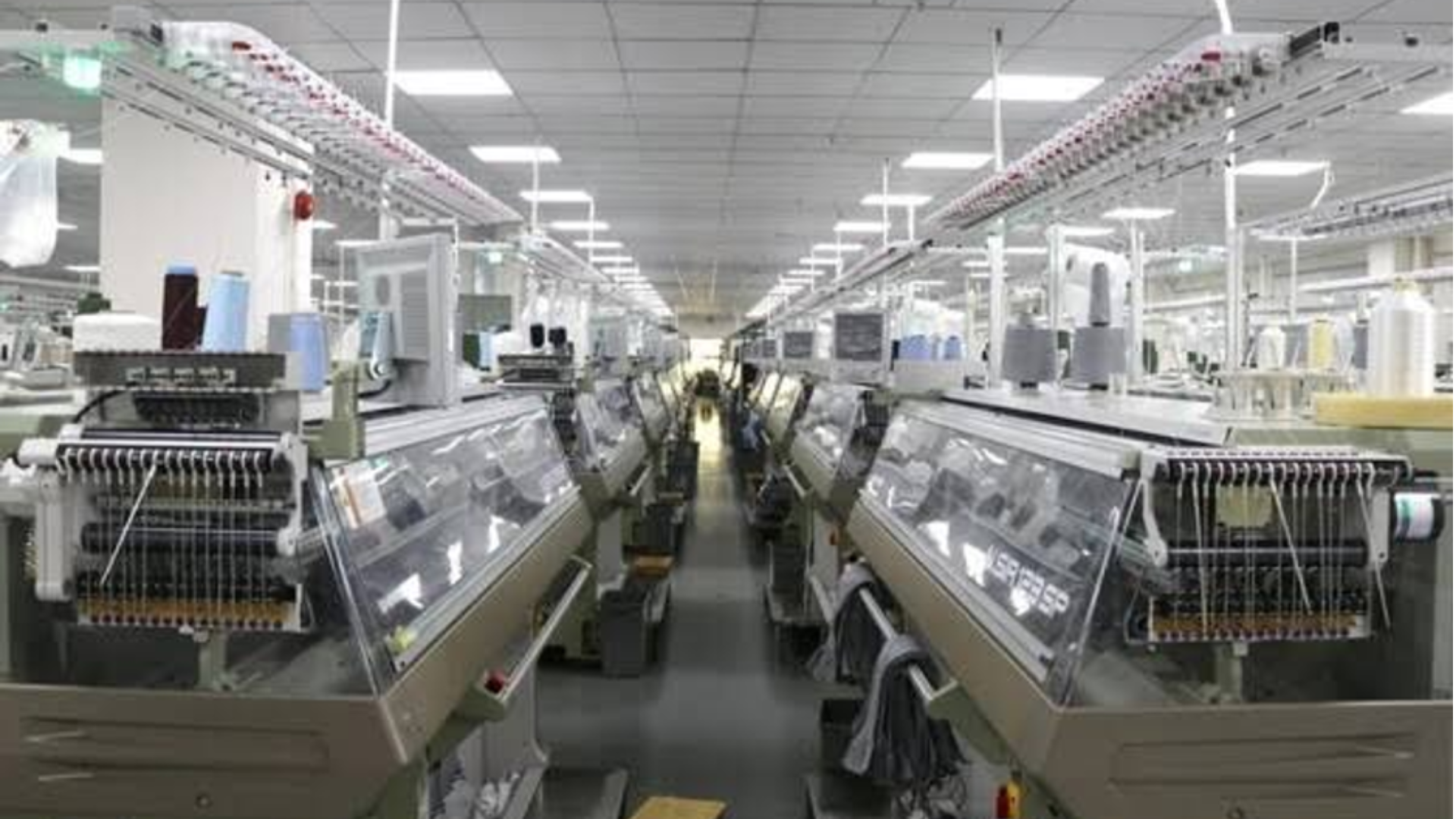Modern textile factory with advanced knitting machines and automated production lines supporting technology-driven services.