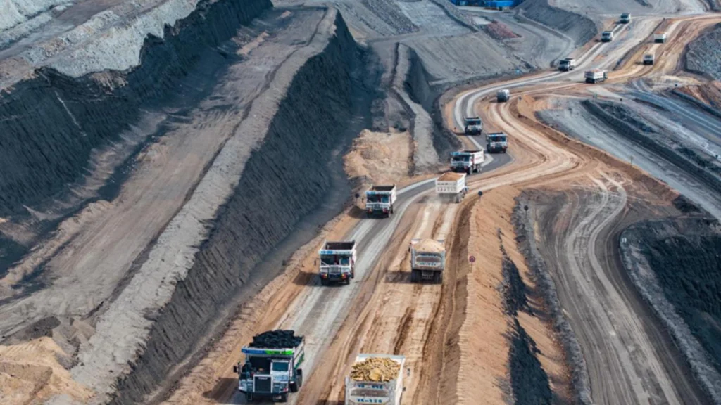 Autonomous new energy mine trucks operate in an open mine in Xinjiang, China.