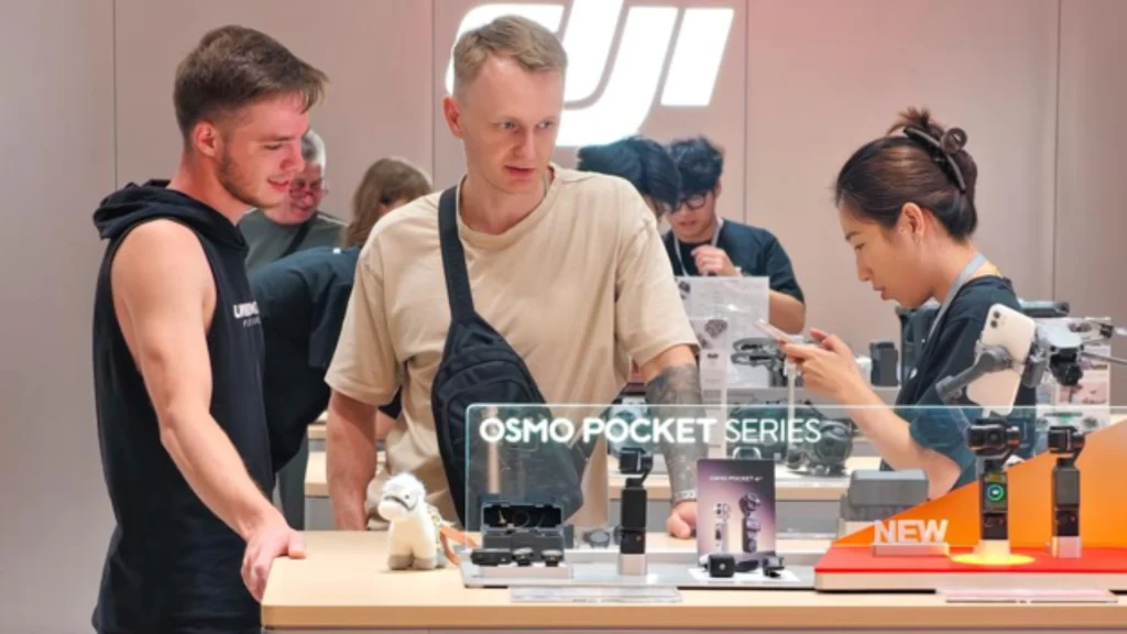 Foreign tourists learn about a gimbal camera at a DJI store in Shanghai.