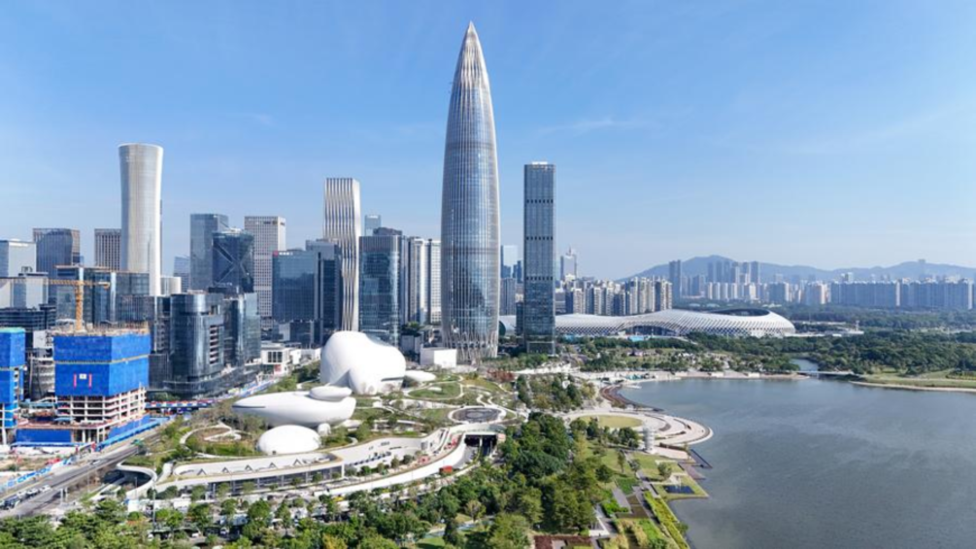 Panoramic skyline view of modern Shenzhen featuring skyscrapers, waterfront parks, and civic architecture.