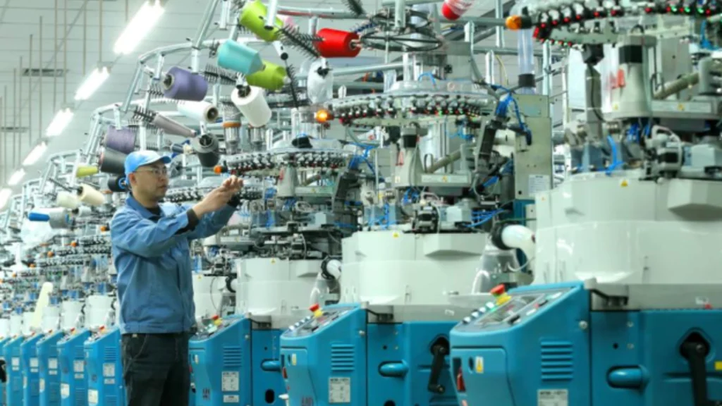 Workers manufacture textile products bound for overseas markets in a Qingdao workshop.