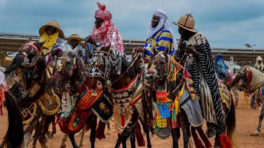 An Emir celebrating Okuta Gaani Festival with Baruba horsemen and traditional drummers in Kwara.