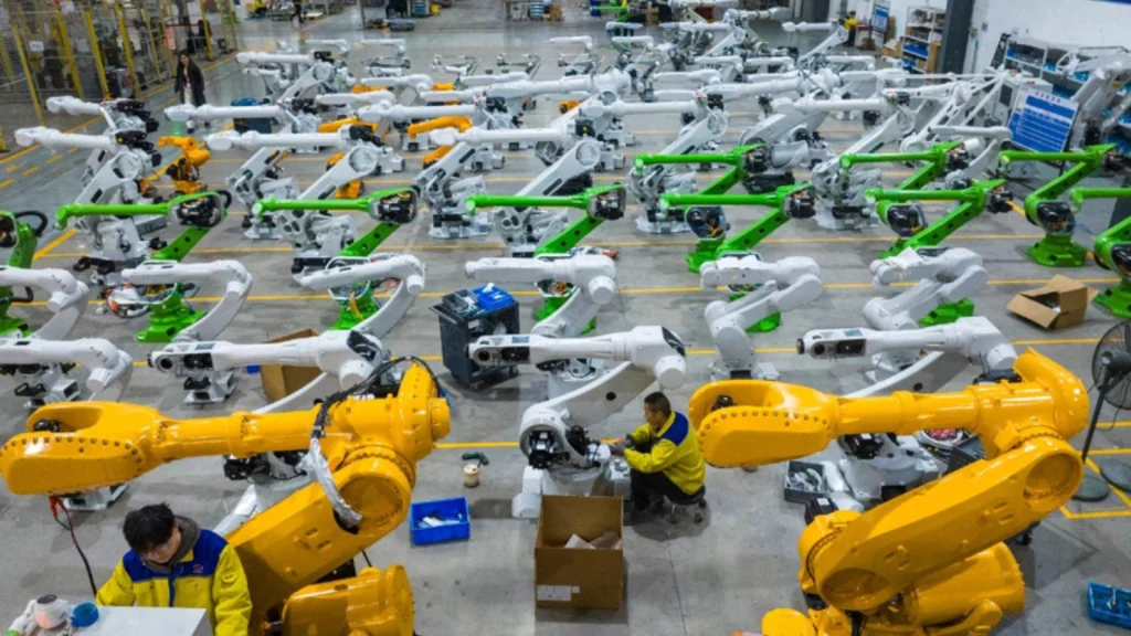 Workers assemble and test industrial robots inside an EFORT workshop in Wuhu, China.