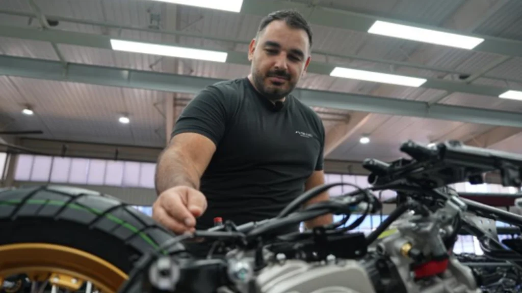 Argentine designer Rodrigo Alvarez fine-tunes a motorcycle on a production line in Taizhou.