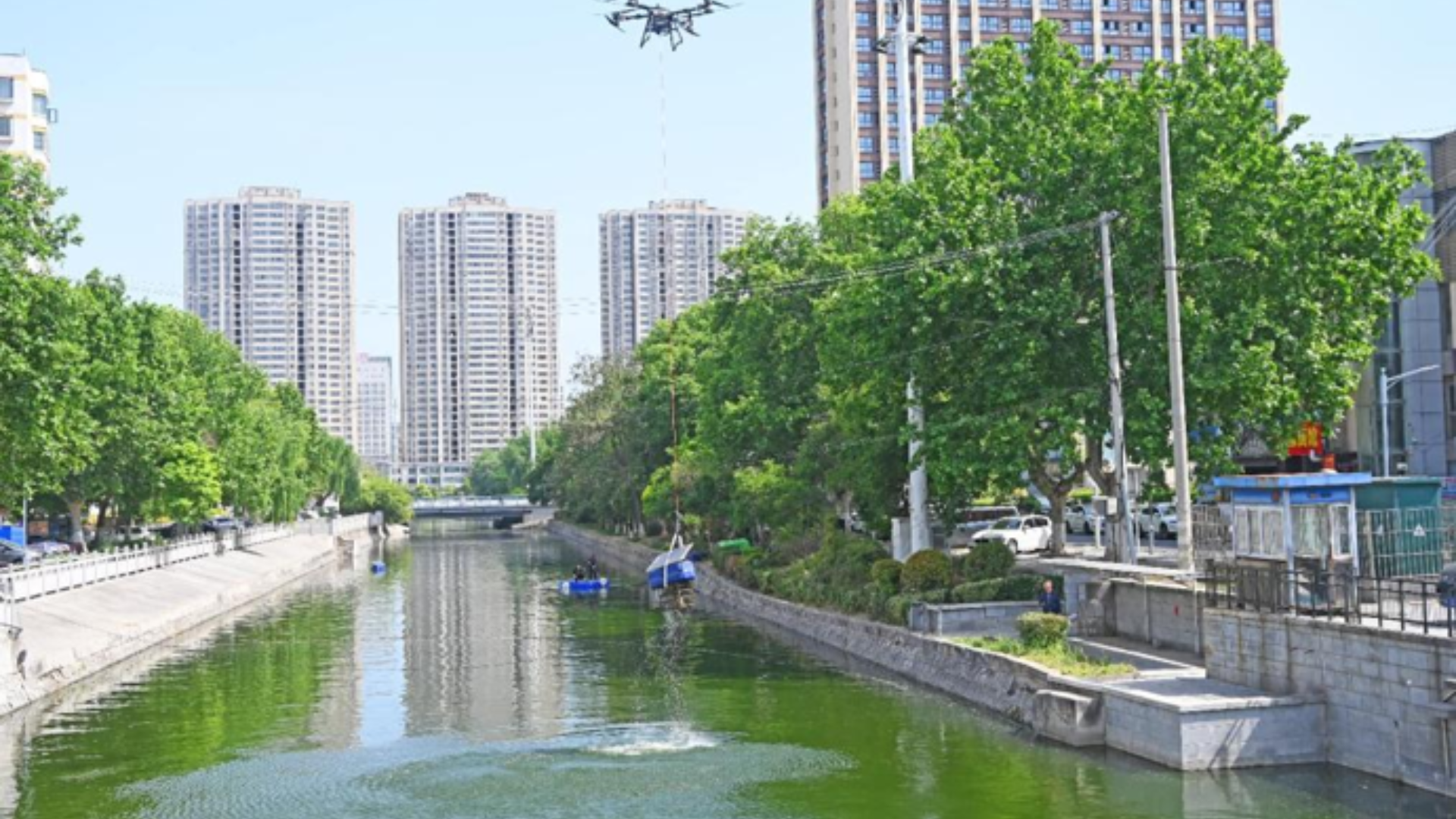 A heavy-lift drone transports ecological-restoration equipment over a moat in Jiangsu, China.